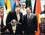  ?? MOHD RASFAN/GETTY-AFP ?? Secretary of State Mike Pompeo, center, chats with North Korean diplomat Ri Yong Ho in Singapore on Saturday.