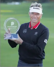  ?? DANIEL SANGJIB MIN – RICHMOND TIMES-DISPATCH VIA AP ?? Bernhard Langer holds his trophy after winning the Dominion Energy Charity Classic on Sunday in Richmond, Va. At 64, he’s the oldest player to win on the PGA Tour Champions.