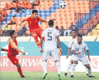  ?? PROVIDED TO CHINA DAILY ?? Midfielder Wei Shihao, who plays his club soccer for Beijing Guo’an, rises high to head home China Under-23s fourth goal in their Asian Games Group C opener against Timor-Leste in Soerang, Indonesia, on Tuesday. China romped to a 6-0 victory over the tiny nation but is expected to face sterner tests against Syria on Thursday and the United Arab Emirates on Sunday. The top two sides in each pool and the four best third-place finishers will advance to the knockout stage.