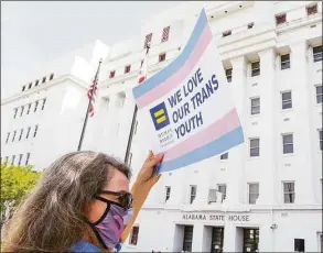  ?? Julie Bennett / Getty Images / Tribune News Service ?? A protester holds a sign that reads “We Love Our Trans Youth” during a March 30 rally at the Alabama State House to draw attention to anti-transgende­r legislatio­n introduced in Alabama.