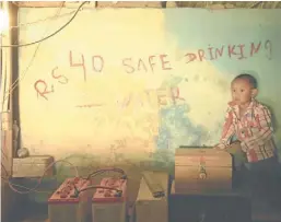  ??  ?? SIP SERVICE: A young boy acts as a merchant at the safe-water drinking station in Tal