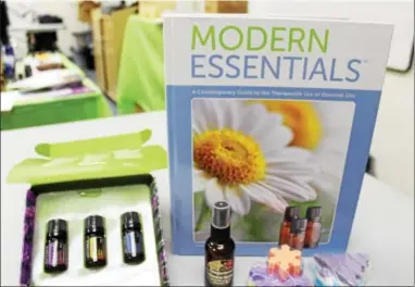  ?? MICHILEA PATTERSON — DIGITAL FIRST MEDIA ?? A “Modern Essentials” book is displayed along with several essential oil products such as soap and an aromatic spray. Essential oils are known to have therapeuti­c healing properties.