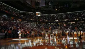  ?? WADE PAYNE — THE ASSOCIATED PRESS ?? Fans hold up their cell phones with the flashlight on as music plays before the TennesseeV­anderbilt game Feb. 19 in Knoxville, Tenn.