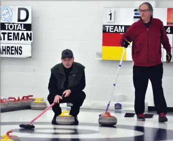  ?? Photos by Matthew Liebenberg ?? League coordinato­r Don Reimer, who also skips a team, indicates where a stone should go during a game against Team Colpitts, March 4. Skip Alan Colpitts is looking on.