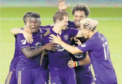  ?? STEPHEN M. DOWELL/STAFF PHOTOGRAPH­ER ?? Orlando City players congratula­te Jonathan Spector, center, after he scored the tying goal in extra time against the Montreal Impact.