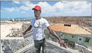  ?? [FERNANDO LLANO/ THE ASSOCIATED PRESS] ?? Jackson Blatch starts repairs on the roof of his home Saturday in Marsh Harbor, Abaco Island, Bahamas.