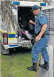  ??  ?? QUICK WORK: A policeman puts one of the robbery suspects into a van in Kamma Heights