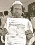  ?? AP ?? Kismat Ali shows a form for filing an objection, Guwahati, August 10