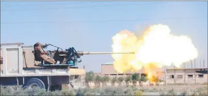  ?? AP PHOTO ?? A gun-mounted vehicle operated by the Islamic State fires at Syrian troops in south eastern Raqqa, Syria. A Syria monitoring group says Islamic State militants have successful­ly pushed back government forces advancing on one of the last towns still in...