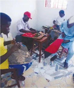  ??  ?? Workers at KAD shoes factory in Kaduna