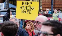  ?? PHOTOS BY NELL CARROLL FOR THE AJC ?? People attending a “Make Athens Safer” rally Tuesday at City Hall blamed Mayor Kelly Girtz for lax immigratio­n laws. ◄