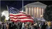  ?? — AP ?? People gather at the Supreme Court in Washington on Saturday night to honour the late Justice Ruth Bader Ginsburg, one of the high court’s liberal justices, and a champion of gender equality.