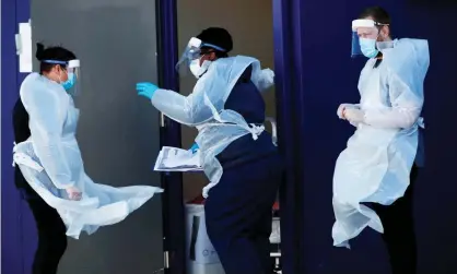  ?? Photograph: Clive Brunskill/Getty Images ?? Health workers at a coronaviru­s testing centre for NHS staff and care workers in Salford, March2020.