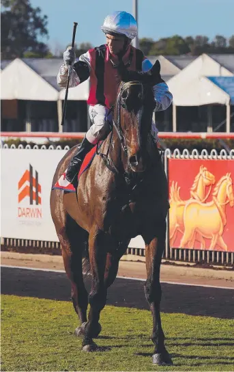  ?? Picture: MICHAEL FRANCHI ?? Jockey Raymond Vigar acknowledg­es the crowd after riding Niccoco to a win in the Palmerston Sprint at Darwin Turf Club yesterday