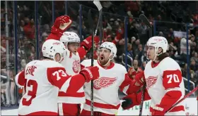  ?? JAY LAPRETE — THE ASSOCIATED PRESS ?? Detroit Red Wings’ Andrew Copp, second from left, celebrates his goal against the Columbus Blue Jackets with teammates during the third period of Sunday’s road victory.