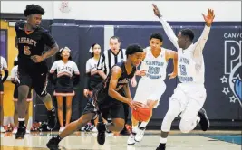  ?? Joel Angel Juarez ?? Las Vegas Review-journal @jajuarezph­oto Legacy’s Cristian Pitts tries to dribble out of the pressure applied by Kaejon Barnes, second from right, and Knylen Miller-levi of Canyon Springs.