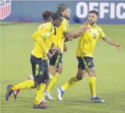  ?? (Photos: AFP) ?? Members of Jamaica’s Reggae Boyz celebrate scoring during their internatio­nal friendly against USA in Wiener Neustadt, Austria, yesterday.