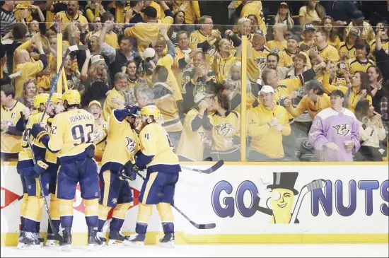  ??  ?? In this April 29, 2018 file photo, Nashville Predators fans celebrate along with players after the Predators scored a goal against the Winnipeg Jets during Game 2 of an NHL hockey second-round
playoff series in Nashville, Tennessee. (AP)