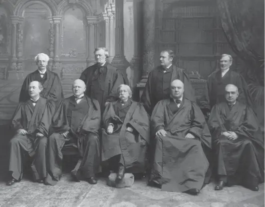  ?? Library of Congress ?? Chief Justice Melville Fuller, center, poses in 1899 with associate justices Rufus W. Peckham, David J. Brewer, George Shiras Jr., John M. Harlan, Edward D. White, Horace Gray, Joseph McKenna and Henry B. Brown.