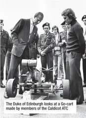  ??  ?? The Duke of Edinburgh looks at a Go-cart made by members of the Caldicot ATC