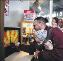  ??  ?? KRISTIN COOKE and daughter Scarlet, 8 months, at an oldtime arcade in San Francisco, as his birth mother looks on.