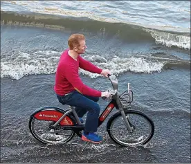  ??  ?? Off course: a Boris Bike, run by the firm, being ridden in the Thames at Putney