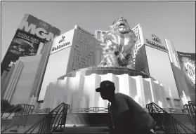  ?? AP Photo/John Locher, File ?? MGM: In this Aug. 3, 2015, file photo, a man rides his bike past the MGM Grand hotel and casino in Las Vegas. The operator of the Mandalay Bay casino-resort from which a gunman carried out the largest mass shooting in U.S. history has filed federal...