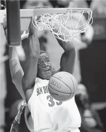  ?? K.C. ALFRED U-T ?? SDSU’s Aguek Arop, who took two of the Aztecs’ four charges and grabbed three of their 12 offensive rebounds, slams homes two of his 10 points against UCLA at Viejas Arena on Wednesday.
