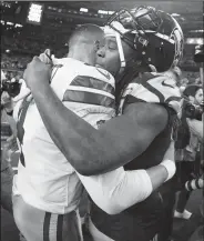  ?? AP/RON JENKINS ?? Dallas Cowboys quarterbac­k Dak Prescott (left) and Seattle Seahawks cornerback Shaquill Griffin embrace Saturday after the NFC wild-card game in Arlington, Texas.