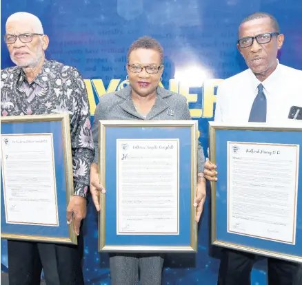  ?? PHOTOS BY RUDOLPH BROWN ?? Enthrose Campbell is sandwiched by Headley ‘Dellmar’ Samuels (left) and Balford Henry as the trio shows off citations they received during a Press Associatio­n of Jamaica Veterans’ Luncheon at the Courtyard Marriott in New Kingston on Wednesday.