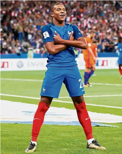  ?? — Reuters ?? Precocious talent: Kylian Mbappe celebrates his goal against Holland in a World Cup qualifying match on Thursday.