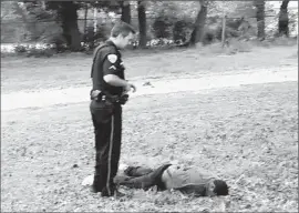  ??  ?? NORTH CHARLESTON Police Officer Michael T. Slager, now charged with murder, stands over the body of Walter L. Scott after shooting him.