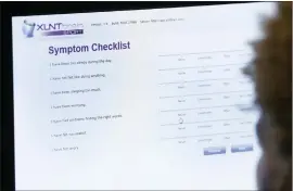  ?? Associated Press ?? In this Sept. 2, 2015, photo, a football player fills out a baseline test that measures reaction time, attention, memory and stress by completing a series of exercises that involve such things as word recognitio­n in Beverly Hills, Mich.
