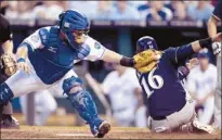  ?? Orlin Wagner/associated Press ?? Aramis Ramirez of the Brewers (16) beats a seventh-inning tag attempt by Royals catcher Humberto Quintero during an interleagu­e matchup at Kansas City, Mo., Tuesday.