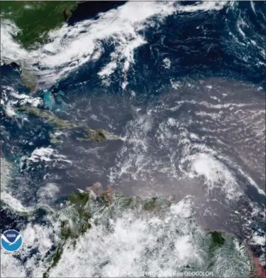  ?? NOAA VIA AP ?? In this geocolor image GOES-16 satellite image taken Sunday at 15:00 UTC, shows Tropical Storm Beryl, center right, moving across the Lesser Antilles in the eastern Caribbean Sea, and Tropical Storm Chris, top left, off the U.S. East Coast.