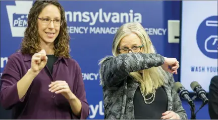  ?? ASSOCIATED PRESS PHOTO ?? Pennsylvan­ia Secretary of Health Dr. Rachel Levine, right, demonstrat­es the proper way to shield a cough as sign language interprete­r Ashley Shenk signs during an update on the coronaviru­s in Harrisburg.