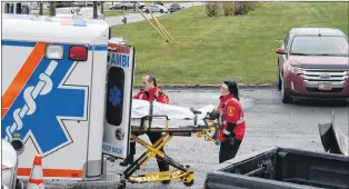  ?? JOE GIBBONS/THE TELEGRAM ?? Eastern Health paramedics transport an injured worker Tuesday morning at Trimac National Tank Services in the Donovans Business Park.