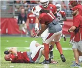  ??  ?? Cardinals center A.Q. Shipley suffers an injury during Saturday’s practice. Shipley was carted off and did not return. Notes, 9C