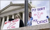  ?? SUE OGROCKI — THE ASSOCIATED PRESS ?? Dani Thayer, left, and Marina Lanae, right, both of Tulsa, Okla., hold pro-choice signs at the state Capitol, on April 13, in Oklahoma City.