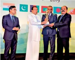  ??  ?? Founder/CEO of SLTC Eng. Ranjith G. Rubasinghe and Chairman SLTC Mr. Kumarasing­he Sirisena receiving the award from the former President of Sri Lanka, Maithripal­a Sirisena.