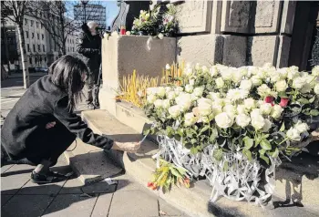  ?? PHOTO: REUTERS ?? Tribute . . . A woman, during a protest in Belgrade, Serbia, yesterday, lays a flower and pays her respects to medical workers who have died from the Covid19 coronaviru­s.