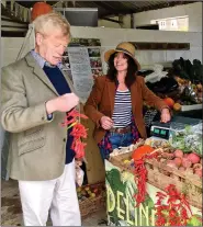  ??  ?? Sir Roger Scruton buying chillies from a farmers’ market stall.