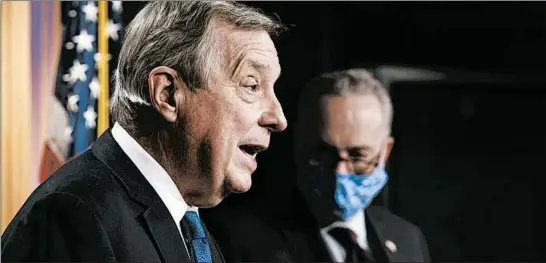  ?? J. SCOTT APPLEWHITE/AP ?? Sen. Dick Durbin, D-Ill., the majority whip, joined at right by Senate Majority Leader Chuck Schumer, D-N.Y., takes a question Tuesday at the Capitol in Washington, D.C.