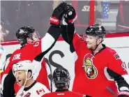  ?? FRED CHARTRAND/The Canadian Press ?? Ottawa Senators Milan Michalek, right, and Mark Stone celebrate a goal against Calgary on Sunday. After being written off, the Senators are making a late playoff push in the East.