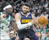  ?? Michael Dwyer The Associated Press ?? Nuggets guard Jamal Murray tries to drive by Celtics guard Jrue Holiday in the second half of Denver’s 102-100 win Friday at TD Garden.