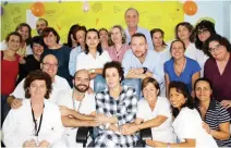  ??  ?? NEW LIFE: Spanish nurse Teresa Romero, first row, center, who was the first person to have contracted Ebola outside Africa, posing with her husband Javier Limon and medical staff. Romero was free from all traces of the virus in her body fluids. (AFP)