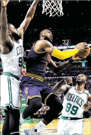  ?? AP/CHARLES KRUPA ?? Cleveland forward LeBron James (center) splits Boston defenders Amir Johnson (left) and Jae Crowder during the first quarter in Game 1 of the NBA Eastern Conference finals Wednesday. The Cavaliers never trailed in coasting to a 117-104 victory behind...