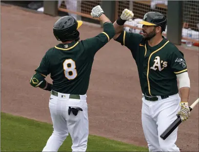  ?? MATT YORK — THE ASSOCIATED PRESS FILE ?? The A’s Jed Lowrie (8) greets Mitch Moreland after hitting a two-run home run against the Mariners during the second inning of a spring game on March 25, in Mesa, Ariz.