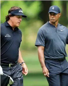  ?? GETTY IMAGES FILES ?? With his win at Pebble Beach earlier this week, Phil Mickelson, left, joined Tiger Woods as the only players to surpass US$90 million in career earnings on the PGA Tour.