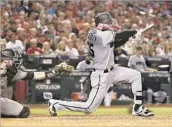  ?? Christian Petersen Getty Images ?? RELIEVER ARCHIE BRADLEY connects for a two-run triple for Arizona in the seventh inning.